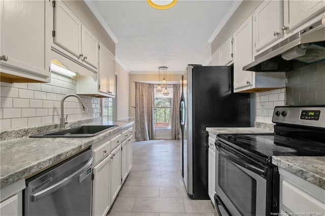 kitchen with under cabinet range hood, a sink, white cabinetry, appliances with stainless steel finishes, and crown molding