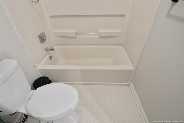 full bathroom with tile patterned flooring, toilet, and washtub / shower combination