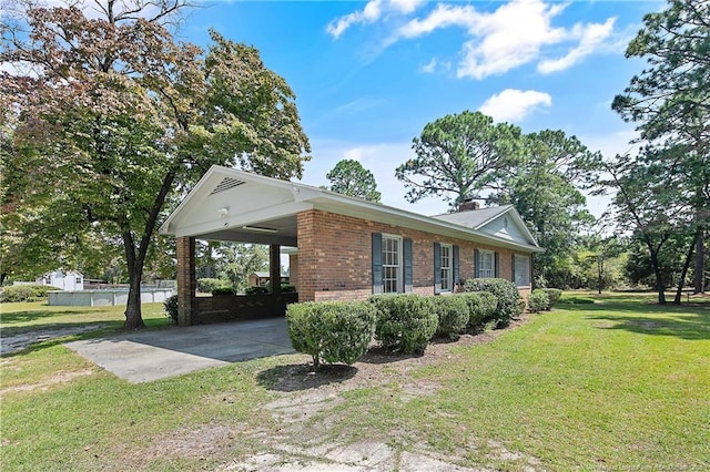 view of home's exterior featuring a yard, driveway, a carport, and brick siding