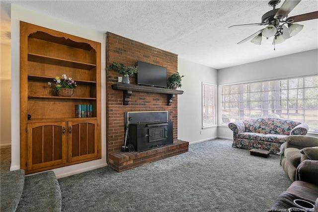 carpeted living area featuring baseboards, a textured ceiling, and ceiling fan