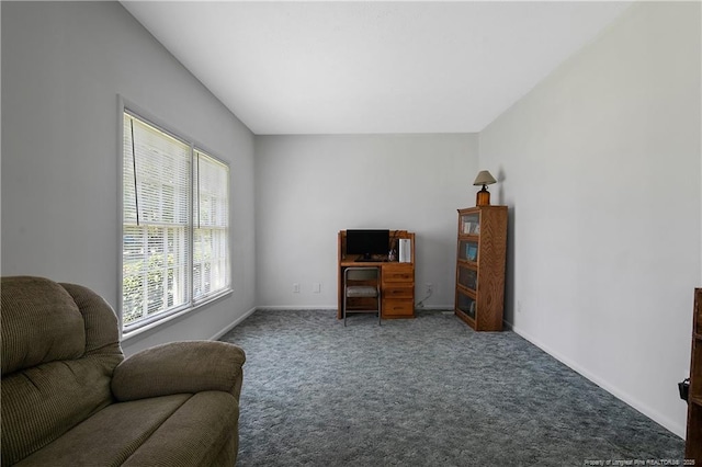 living area with baseboards and carpet flooring