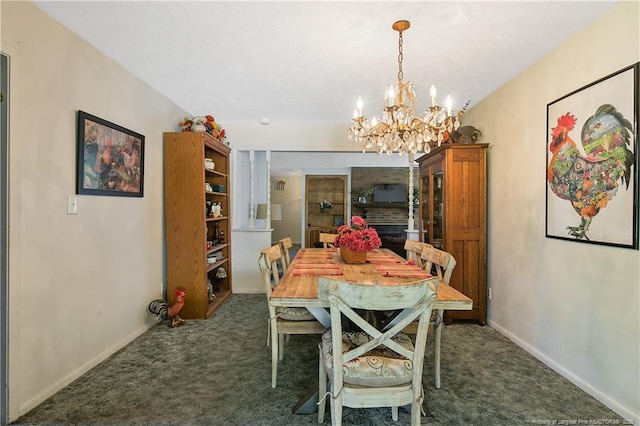 dining room featuring baseboards, an inviting chandelier, and dark carpet