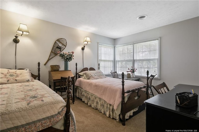 bedroom featuring visible vents and light carpet