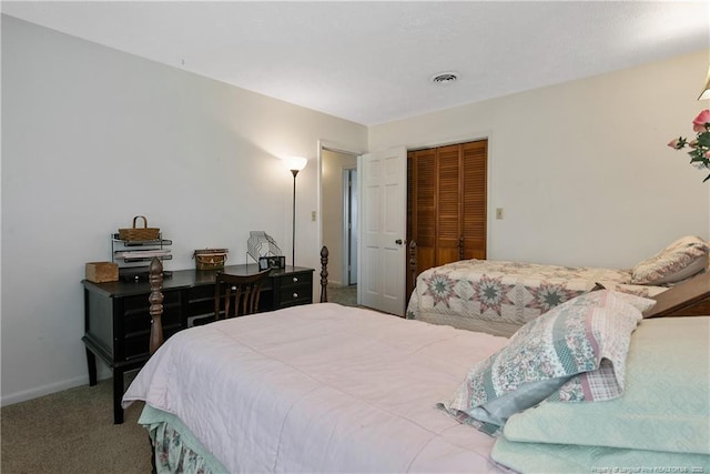 bedroom with a closet, visible vents, baseboards, and carpet floors