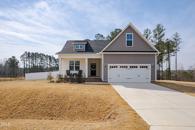 view of front of property with covered porch, concrete driveway, an attached garage, and a shingled roof