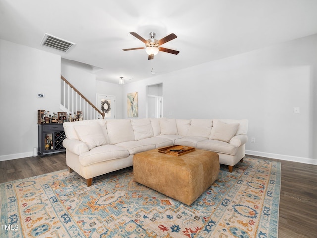 living room with visible vents, baseboards, ceiling fan, and wood finished floors