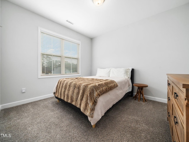 carpeted bedroom with visible vents and baseboards