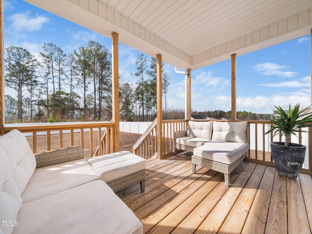 wooden terrace with an outdoor hangout area