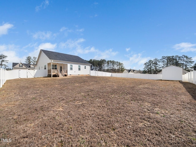 back of property with crawl space, a lawn, and a fenced backyard