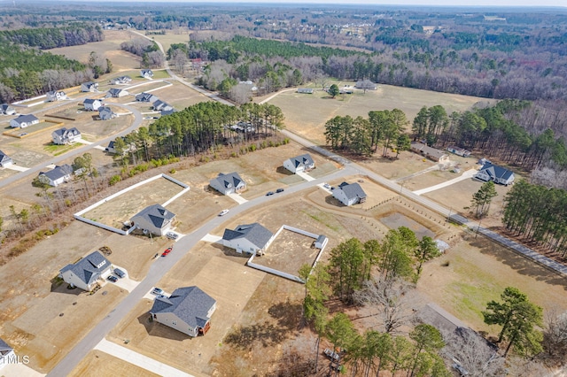 birds eye view of property with a forest view