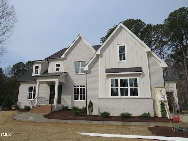 modern inspired farmhouse with brick siding and board and batten siding