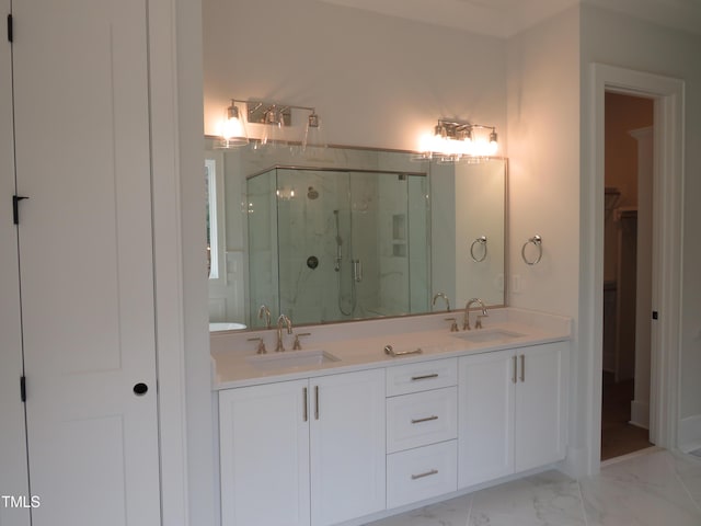 full bathroom featuring double vanity, marble finish floor, a marble finish shower, and a sink