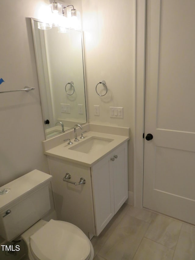 bathroom featuring vanity, an inviting chandelier, and toilet