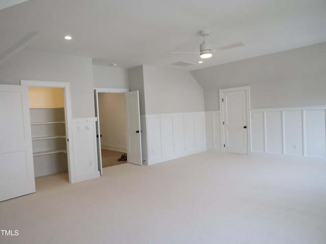 additional living space featuring a wainscoted wall, light carpet, recessed lighting, ceiling fan, and vaulted ceiling