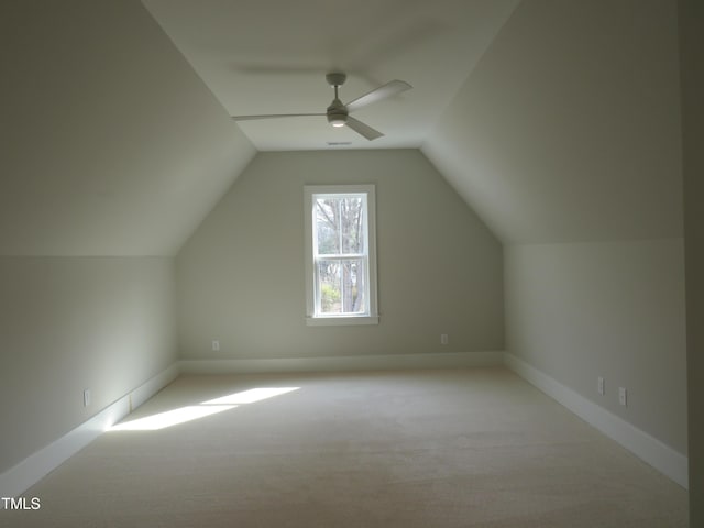 bonus room with lofted ceiling, baseboards, carpet floors, and ceiling fan