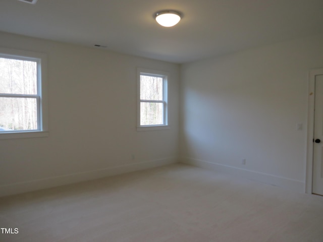 spare room with visible vents, baseboards, and a healthy amount of sunlight