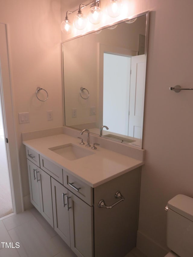 bathroom featuring tile patterned floors, toilet, and vanity