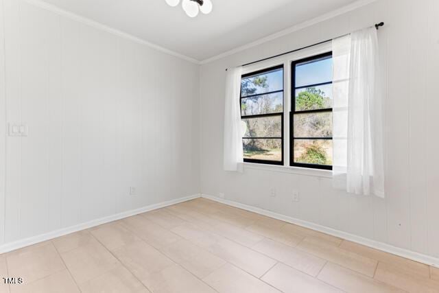 spare room with baseboards and ornamental molding