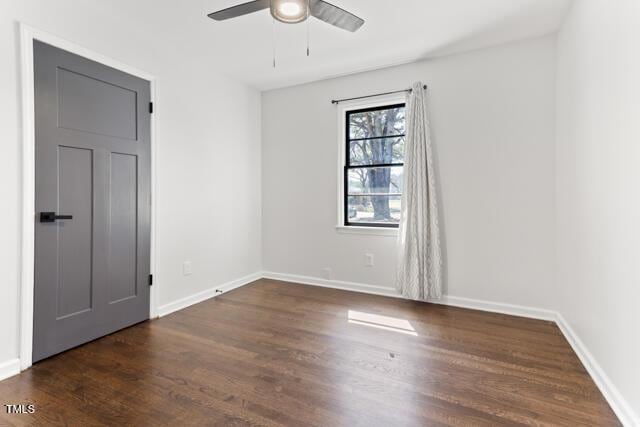 empty room with baseboards, wood finished floors, and a ceiling fan