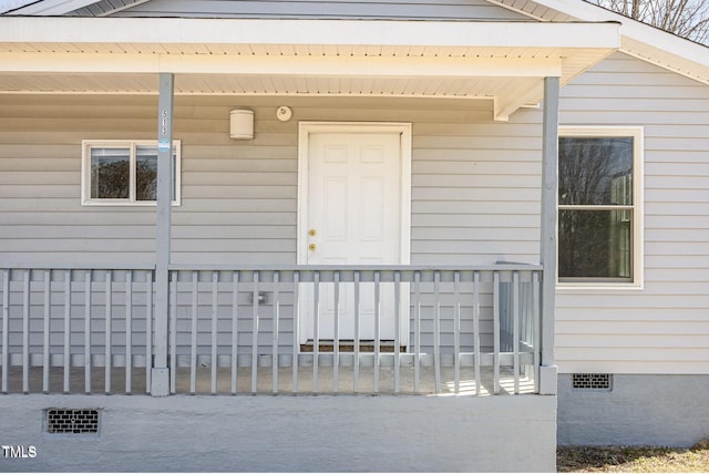 entrance to property with covered porch and crawl space