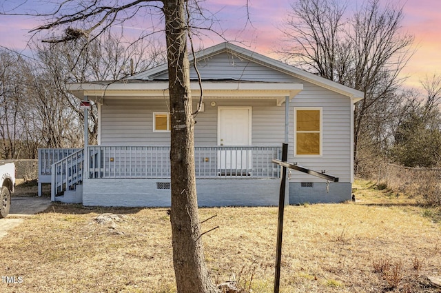 bungalow-style home with covered porch and crawl space