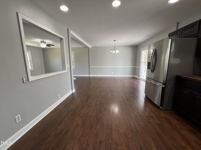 kitchen with a chandelier, dark wood-type flooring, baseboards, and stainless steel fridge with ice dispenser