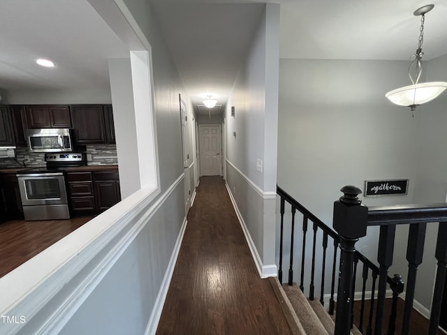 corridor with recessed lighting, baseboards, and dark wood finished floors