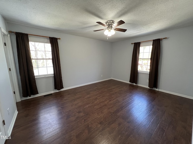 unfurnished room featuring baseboards, dark wood-style flooring, and a ceiling fan