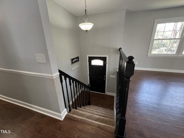 entryway featuring stairway, baseboards, and wood finished floors