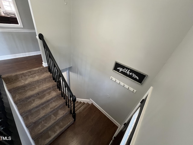 stairway with baseboards and wood finished floors