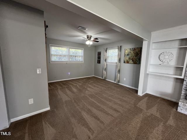 interior space with visible vents, built in shelves, carpet, baseboards, and ceiling fan