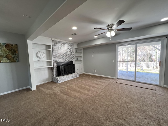 unfurnished living room featuring visible vents, built in shelves, ceiling fan, baseboards, and carpet floors