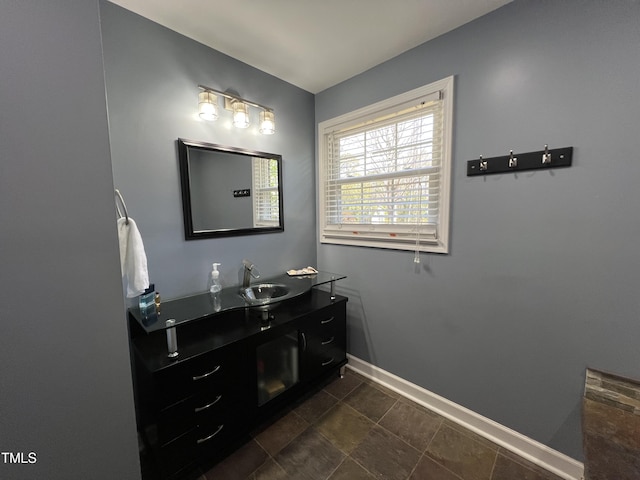 bathroom with vanity and baseboards