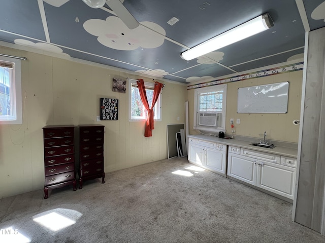 interior space featuring carpet flooring, cooling unit, and a sink