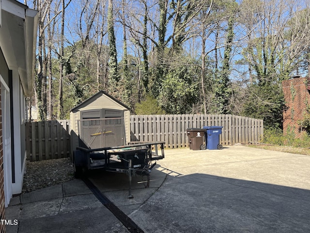 view of patio / terrace featuring a fenced backyard, a storage shed, and an outdoor structure