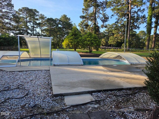 5350 Clubhouse Ln, Hope Mills, NC 28348 - outdoor pool with a patio and view of scattered trees