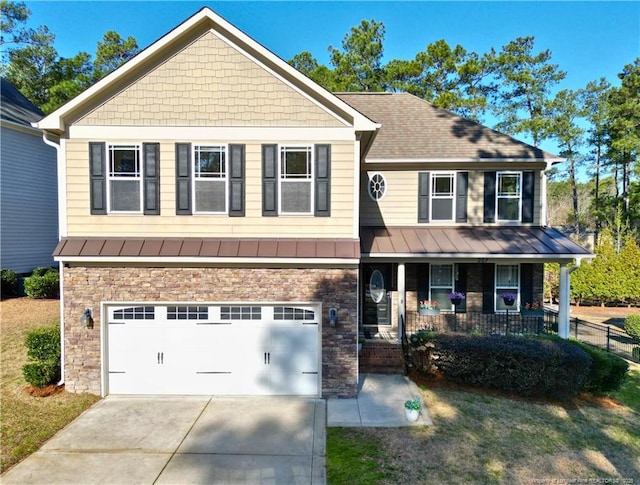 craftsman-style home featuring a standing seam roof, covered porch, concrete driveway, an attached garage, and metal roof