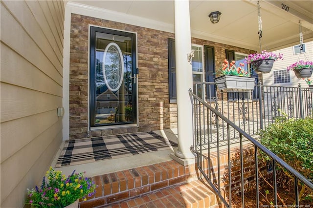 entrance to property with covered porch and stone siding