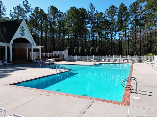 pool featuring a patio and fence