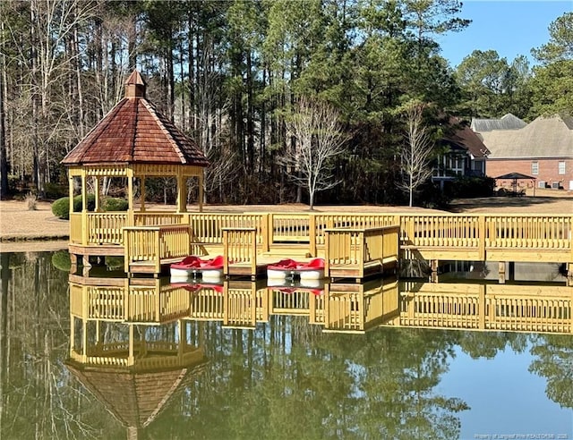 dock area with a gazebo and a water view