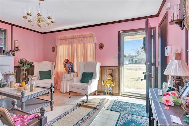 sitting room with crown molding and a chandelier