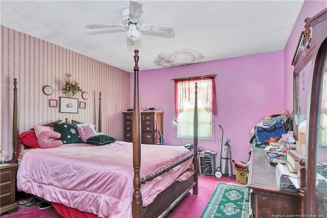 carpeted bedroom featuring wallpapered walls, ceiling fan, and a textured ceiling