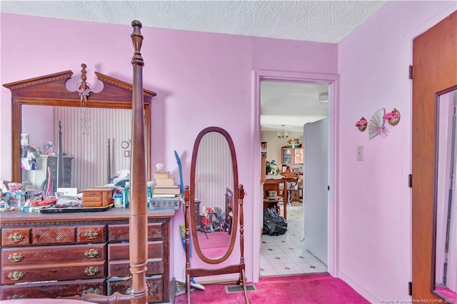 bedroom with tile patterned floors and a textured ceiling