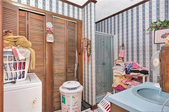 full bath with vanity, a textured ceiling, a shower stall, and wallpapered walls