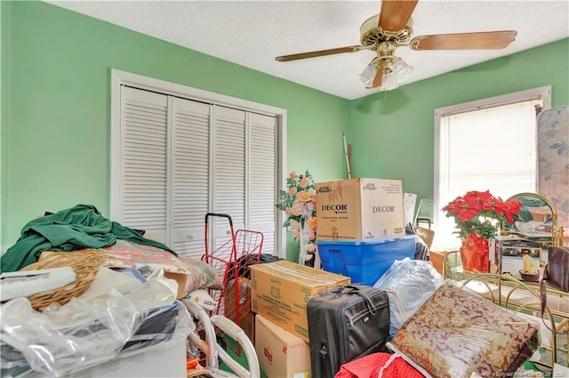 bedroom with a ceiling fan, a closet, and a textured ceiling