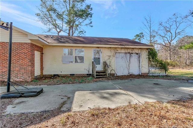 back of property with entry steps and crawl space