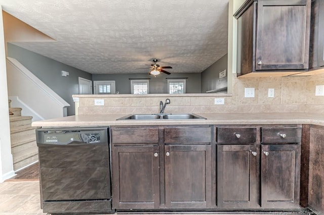 kitchen featuring black dishwasher, dark brown cabinets, and a sink