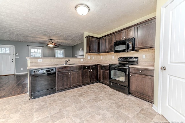 kitchen with a ceiling fan, a sink, black appliances, dark brown cabinetry, and light countertops