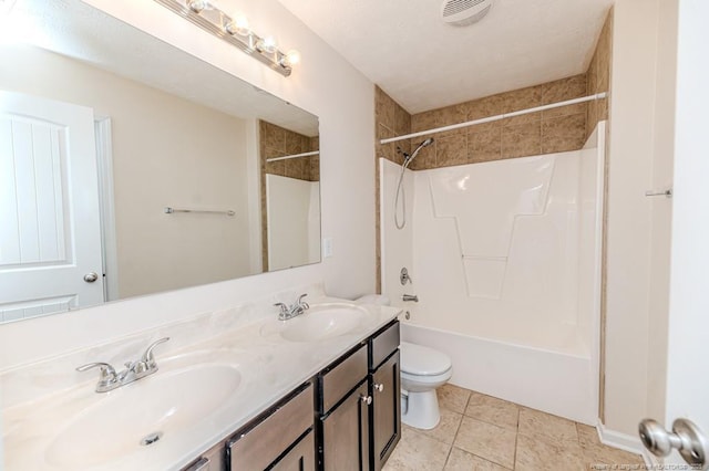 full bathroom with a sink, toilet, double vanity, and tile patterned floors