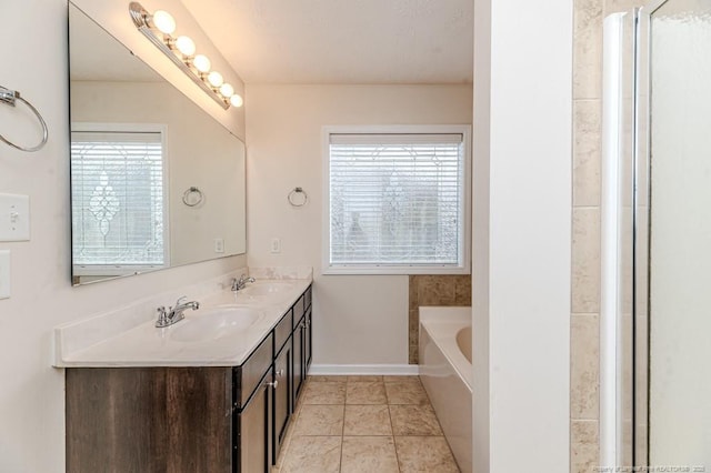 full bathroom with tile patterned flooring, a garden tub, baseboards, and a sink